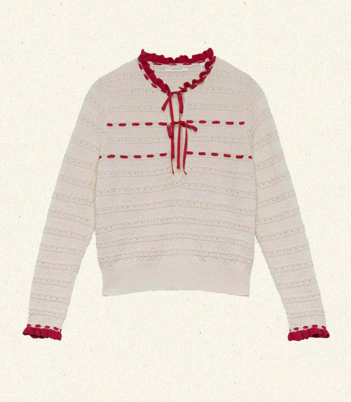 The Cordelie Top in a cream and red baby alpaca-silk blend and silk grosgrain ribbons that tie at the neck.