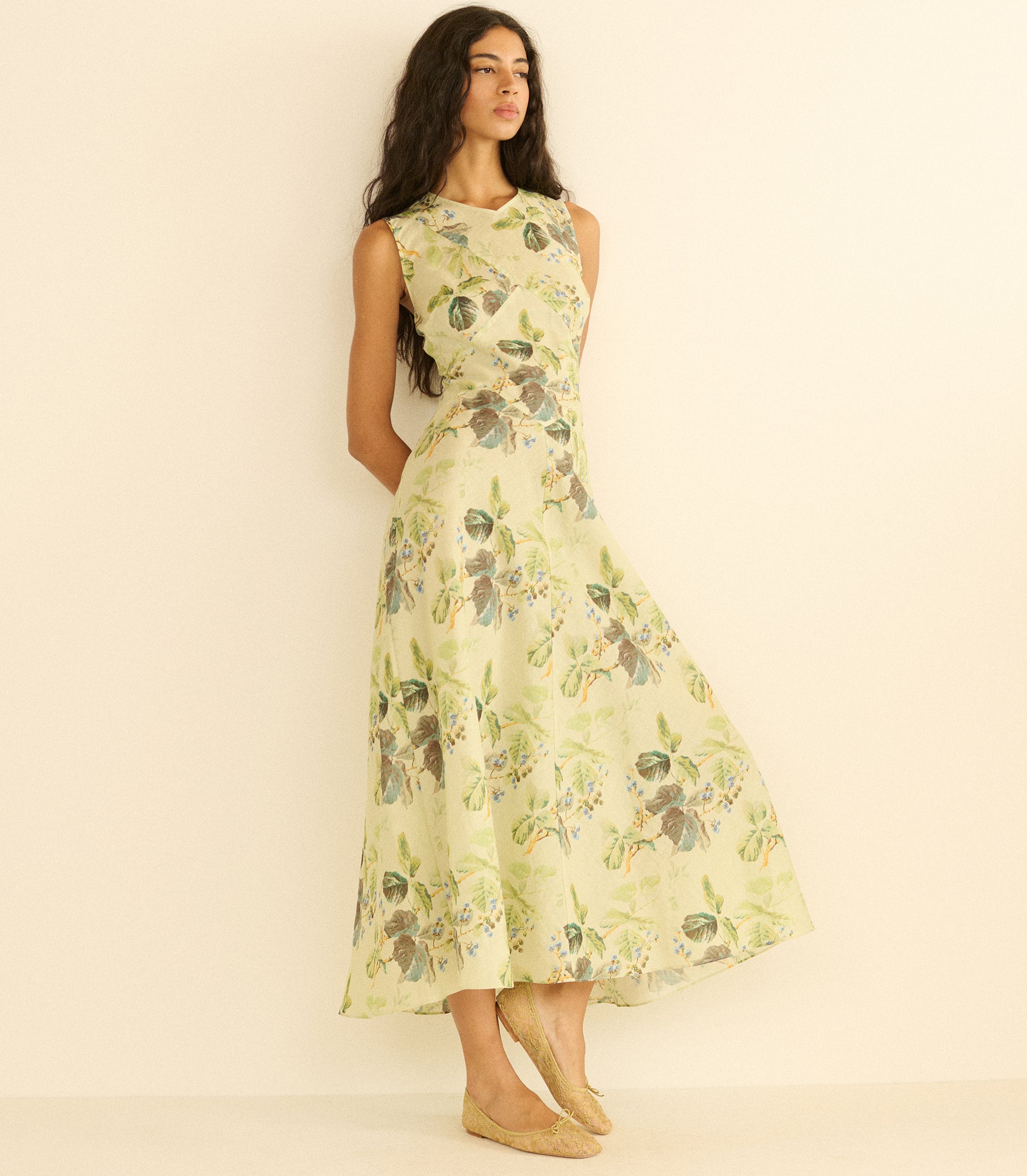 Woman wearing a floral dress against a plain background 1
