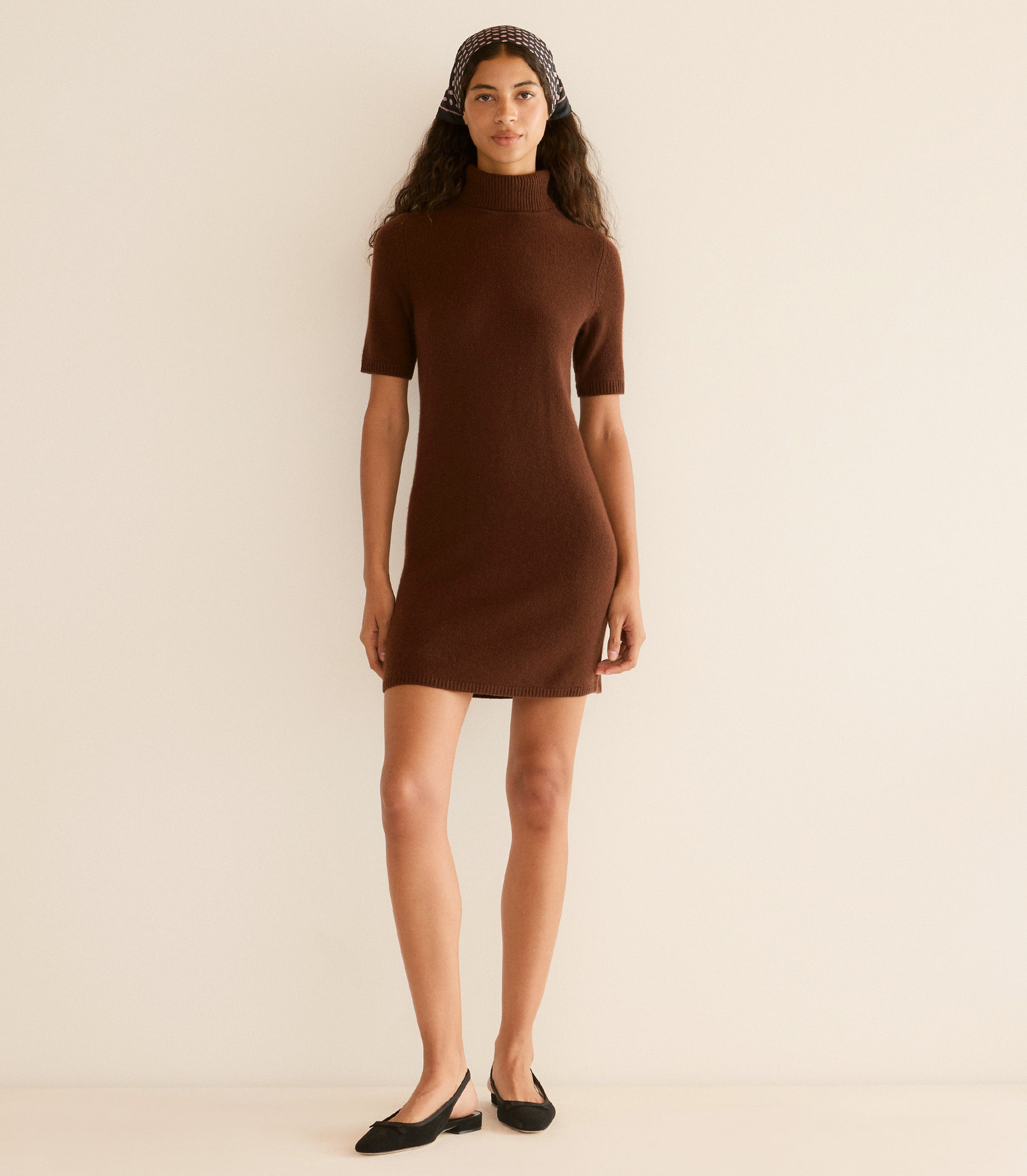 Woman wearing a brown dress against a beige background 2