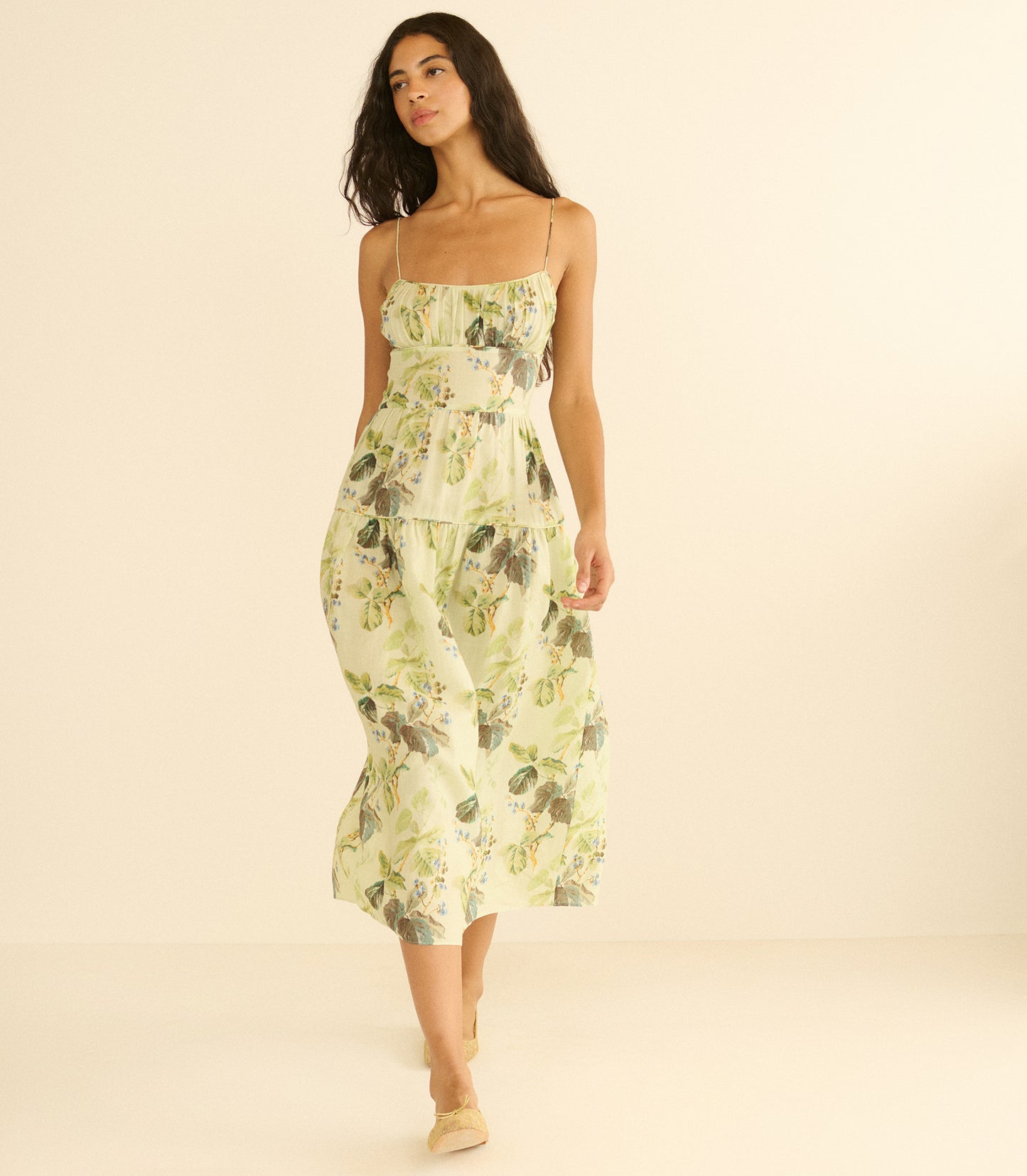 Woman wearing a floral dress on a beige background