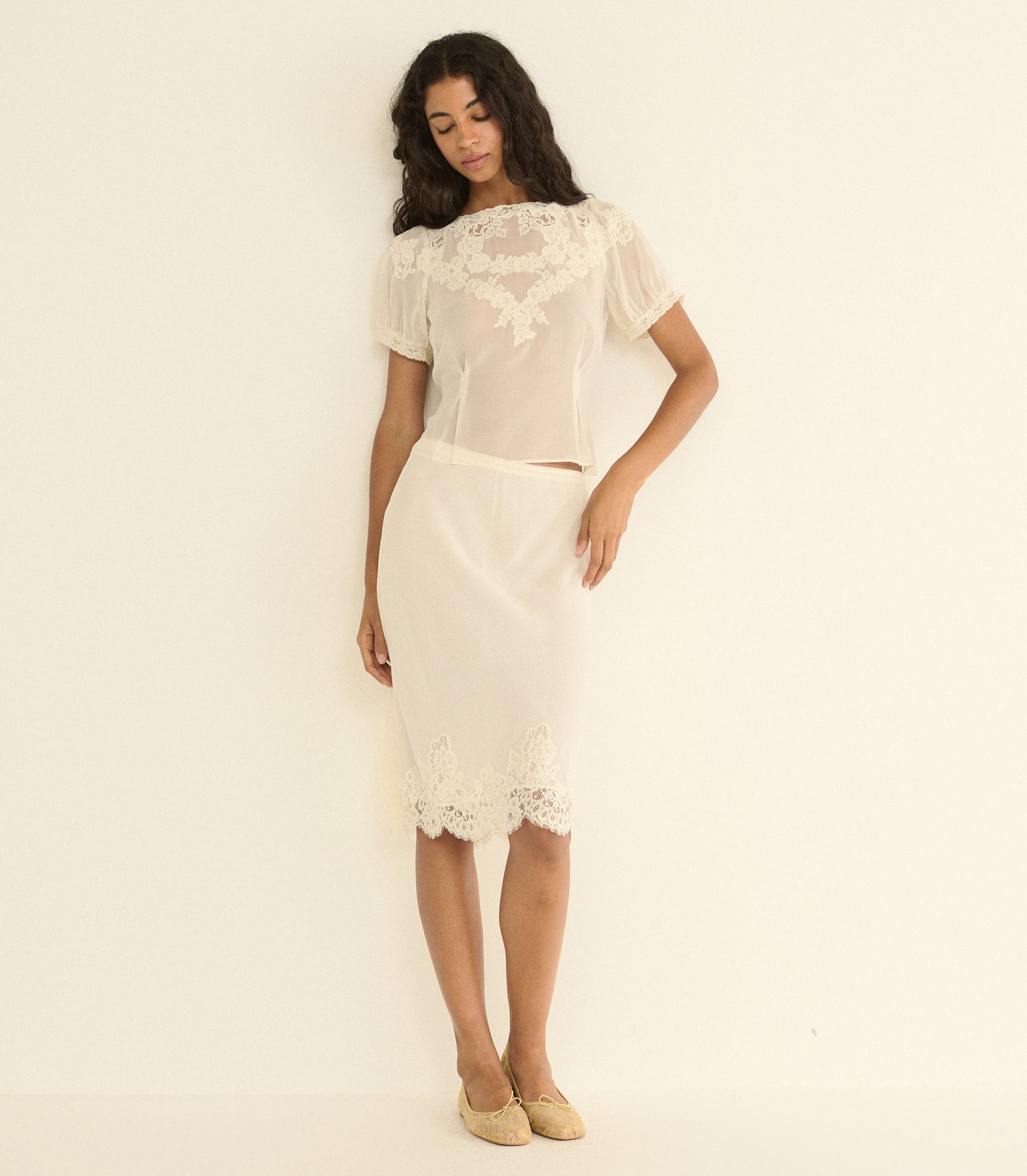 Woman wearing a white skirt outfit on a plain background 1

