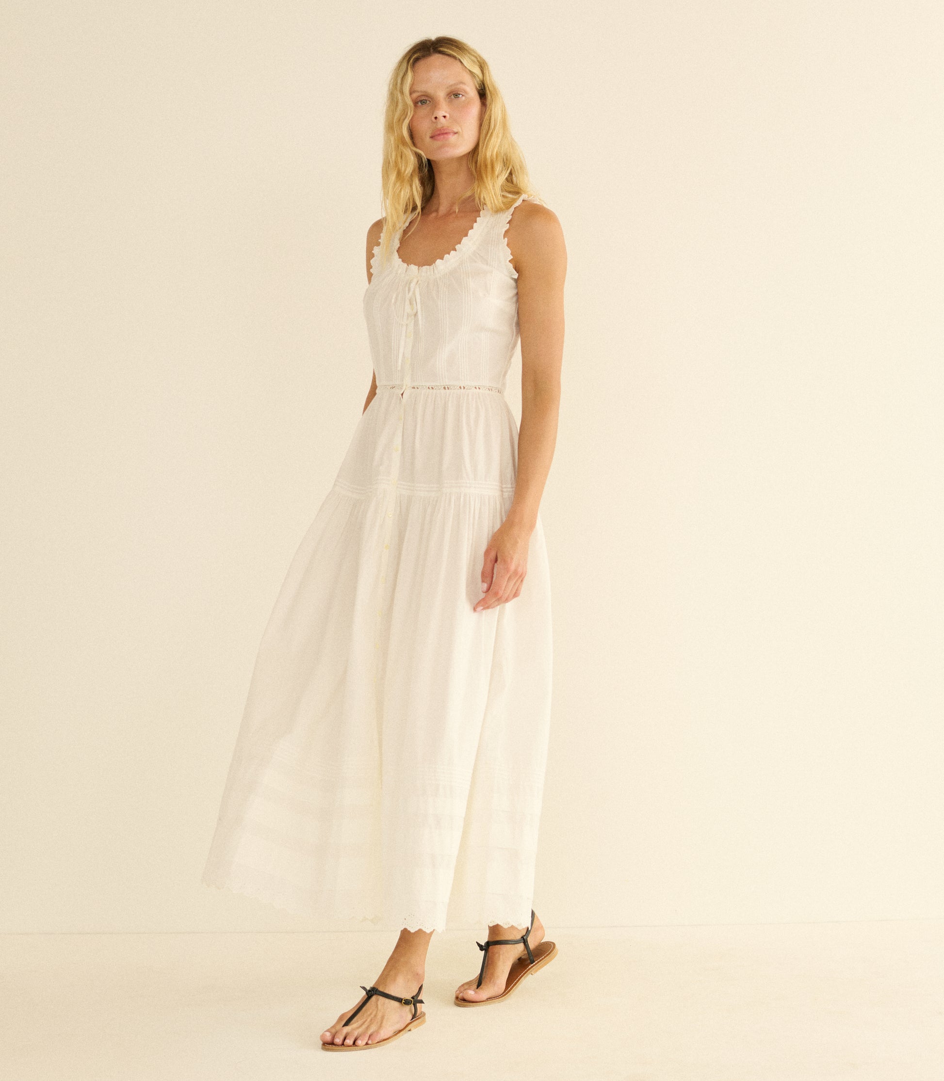 Woman wearing a white dress on a beige background 1
