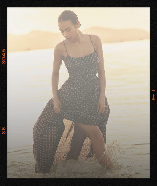 Woman in a printed dress in the ocean