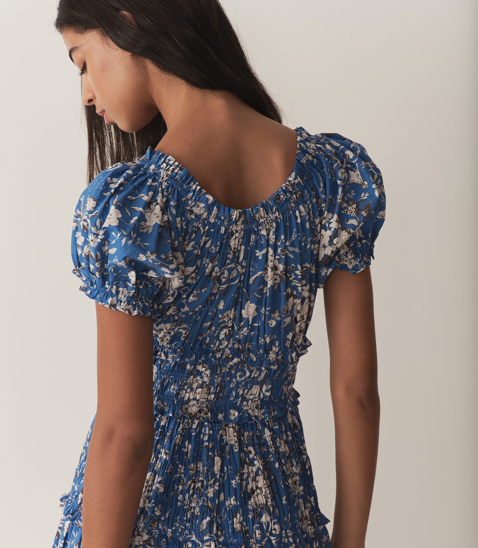 Rocio is wearing a long blue and white floral dress. 4