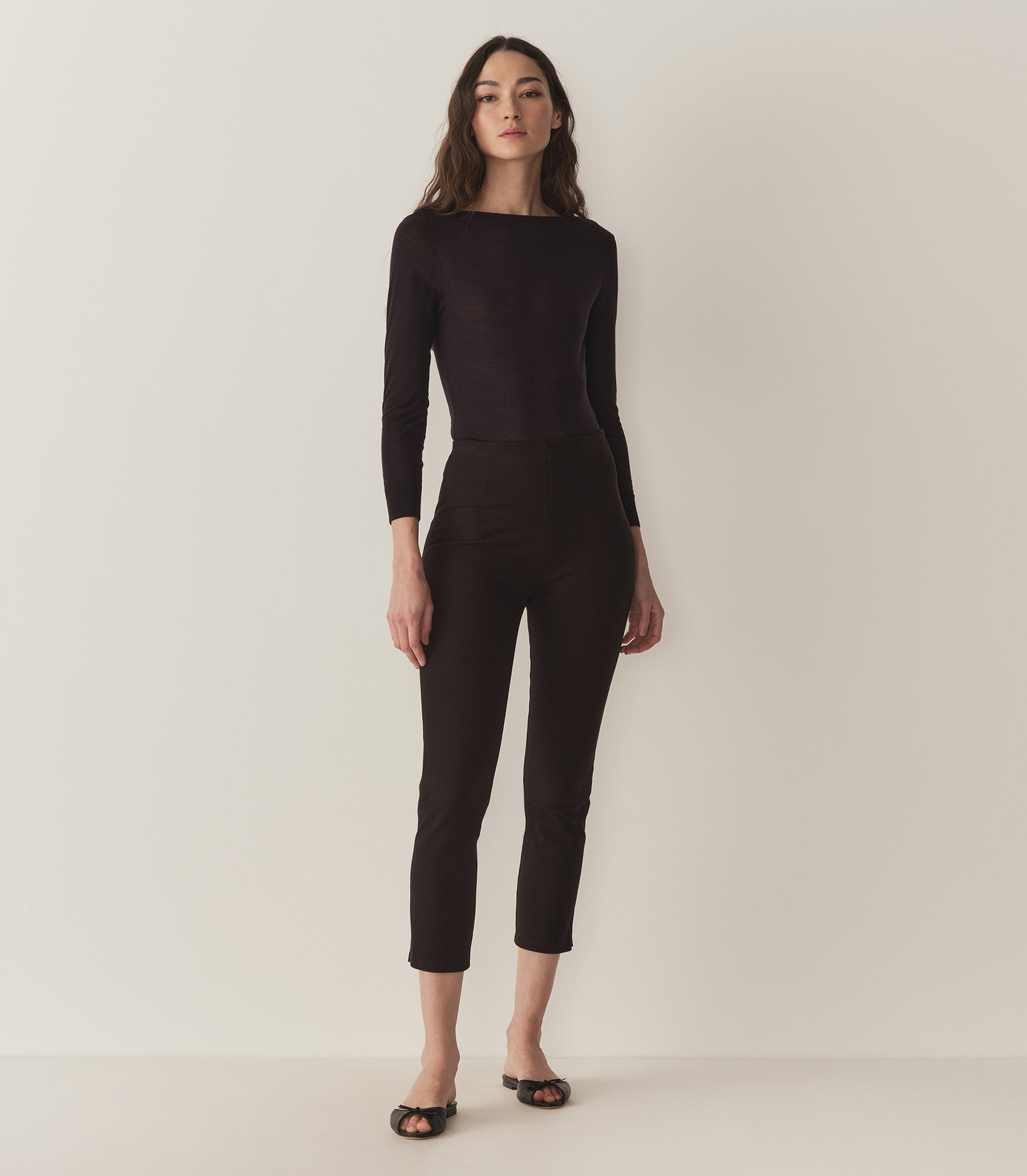 Rocio is wearing a cardigan and black capri pants. 4