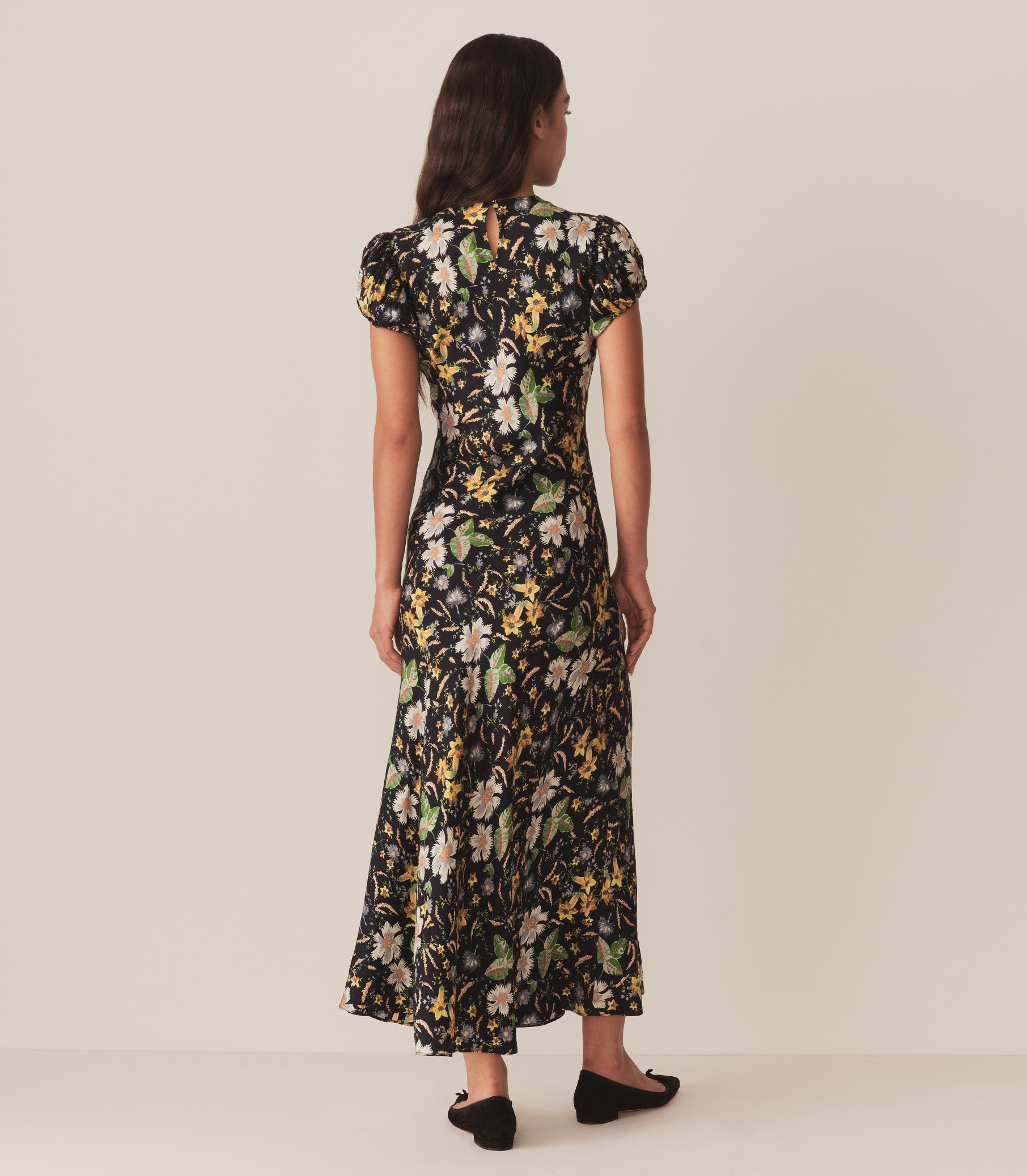 Zahara wears the bias-cut Merla Dress in Art Deco-inspired Sweet Anemone,  featuring a high neck and short puffed sleeves. 6