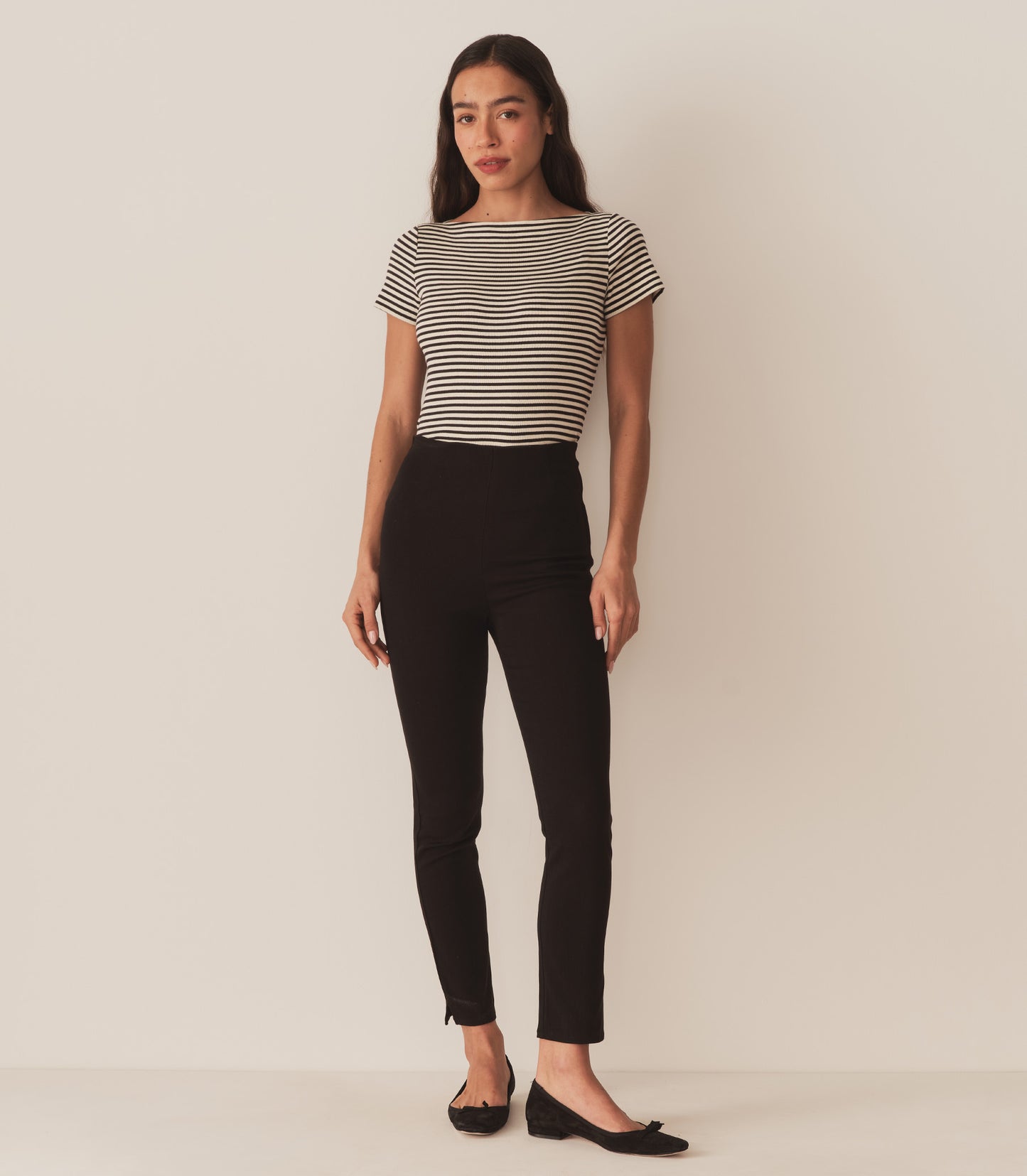 Zahara wears a black and white striped tee with black pants.