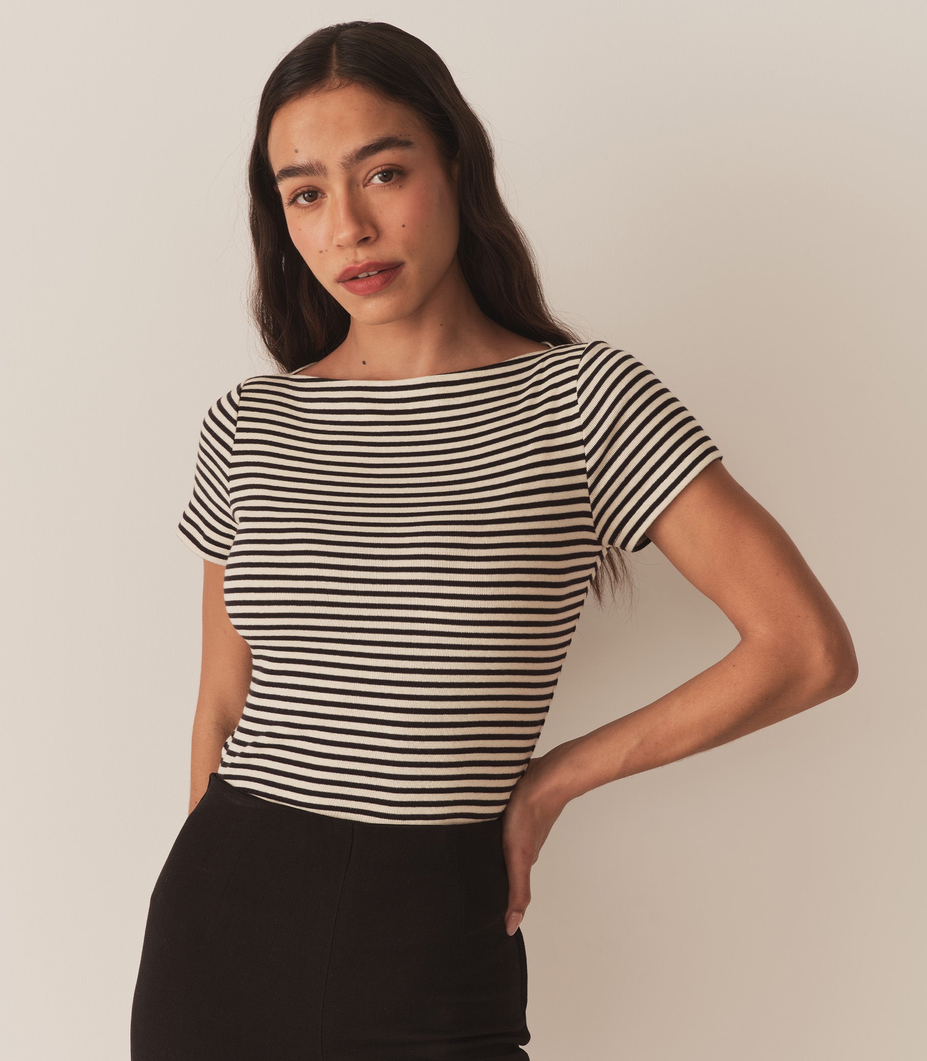 Zahara wears a black and white striped tee with black pants. 3